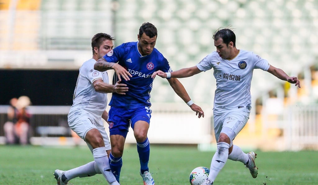 Eastern's Lucas tries to escape the attentions of his R&F rivals in the 2019-20 Hong Kong Premier League title decider at Hong Kong Stadium. Photo: HKFA