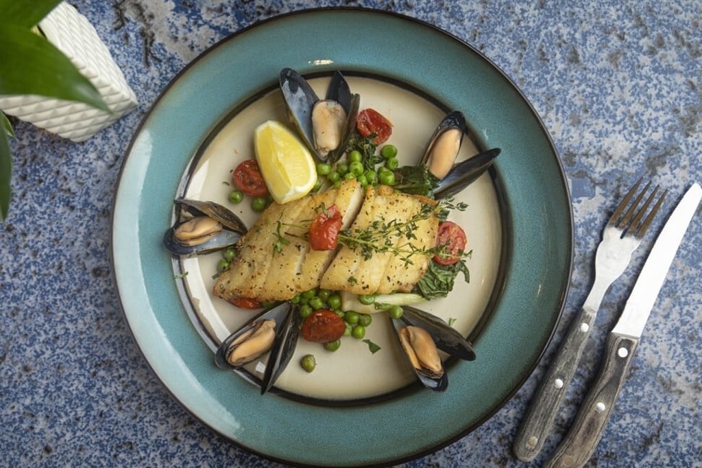 Halibut with mussels and peas at Flying Pig Bistro. Photo: Handout Halibut with mussels and peas at Flying Pig Bistro. Photo: Handout
