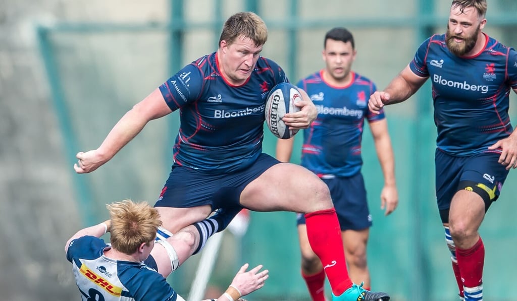 Hong Kong Scottish prop Jack Parfitt steps over HKFC’s Sam Pim in a Hong Kong Premiership match in 2019. Photo: Phoebe Leung Hong Kong Scottish prop Jack Parfitt steps over HKFC’s Sam Pim in a Hong Kong Premiership match in 2019. Photo: Phoebe Leung
