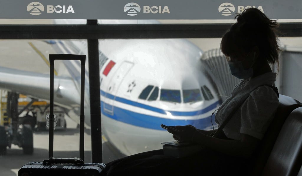 A woman browses her smartphone at the Beijing Capital International Airport. A new study shows that smartphone addiction is related to the number of children a person has. Photo: AP