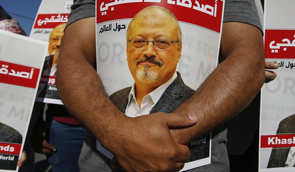 People hold posters of slain journalist Jamal Khashoggi near the Saudi Arabia consulate in Istanbul on October 2, marking the two-year anniversary of his death. Photo: AP