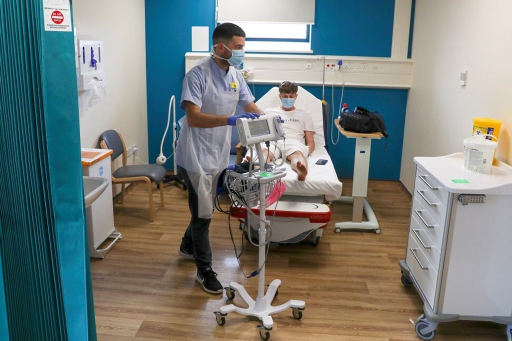 A nurse treats a Covid-19 patient in a hospital in southern England. Photo: AFP A nurse treats a Covid-19 patient in a hospital in southern England. Photo: AFP