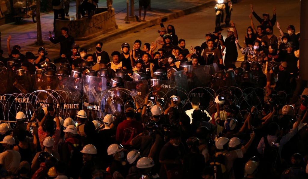 Pro-democracy protesters scuffle with the police as they march towards the Government House in Bangkok on October 21. Photo: Reuters