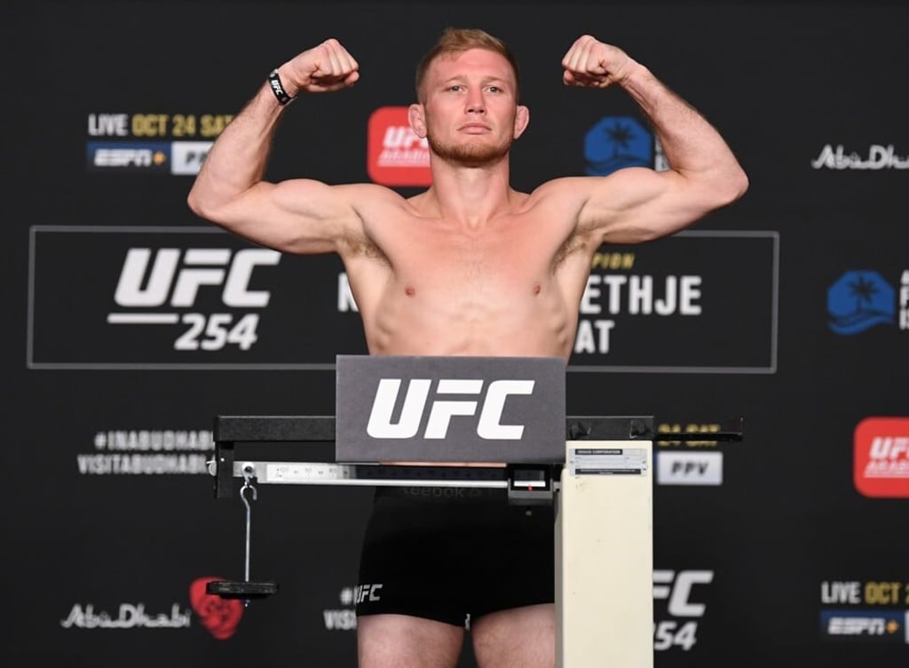 Casey Kenney poses on the scale during the UFC 254 weigh-in on October 23, 2020 on UFC Fight Island, Abu Dhabi, United Arab Emirates.