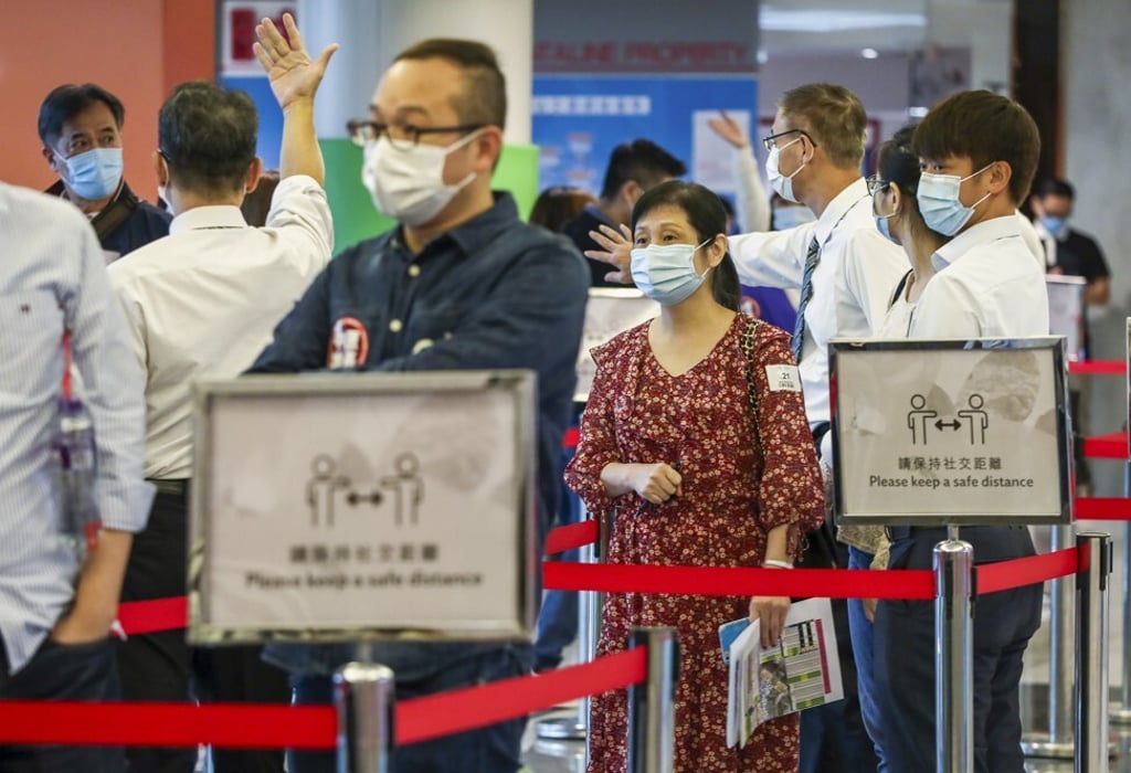 Prospective homebuyers line up at the sales office of The Pavilia Farm in Tsuen Wan, on Sunday. Photo: Jonathan Wong