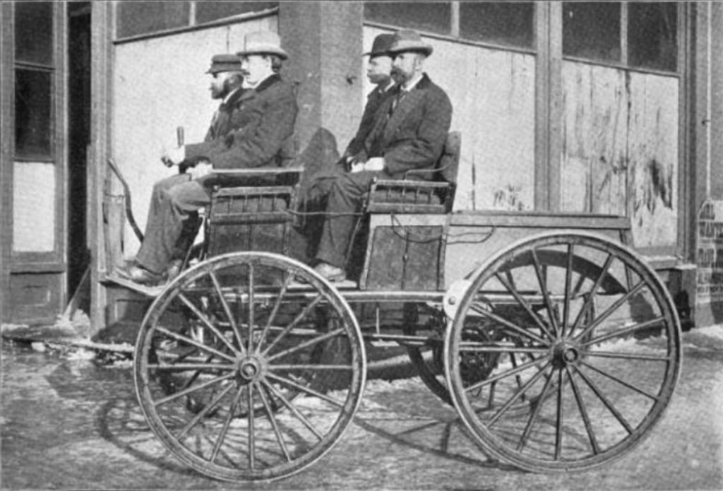 A Sturgis Morrison electric carriage in 1895, modified with extra batteries under the front row and the back to give additional power for he Times-Herald automobile race. Source: Unknown author, Wikipedia. A Sturgis Morrison electric carriage in 1895, modified with extra batteries under the front row and the back to give additional power for he Times-Herald automobile race. Source: Unknown author, Wikipedia.