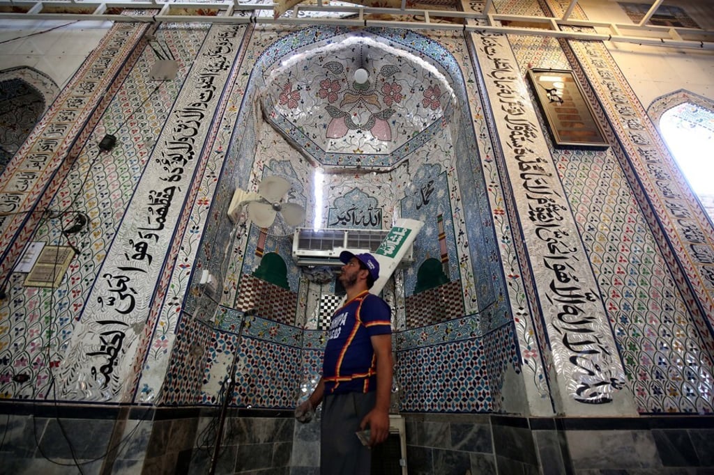 A rescuer inspects the scene of an explosion at an Islamic seminary in Peshawar. Photo: EPA-EFE A rescuer inspects the scene of an explosion at an Islamic seminary in Peshawar. Photo: EPA-EFE