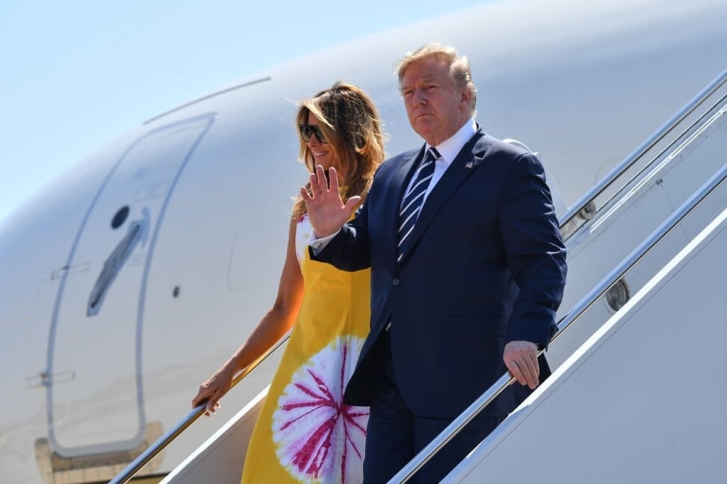 President Donald Trump flanked by his wife Melania arriving in France in 2019. Photo: Agence France-Presse