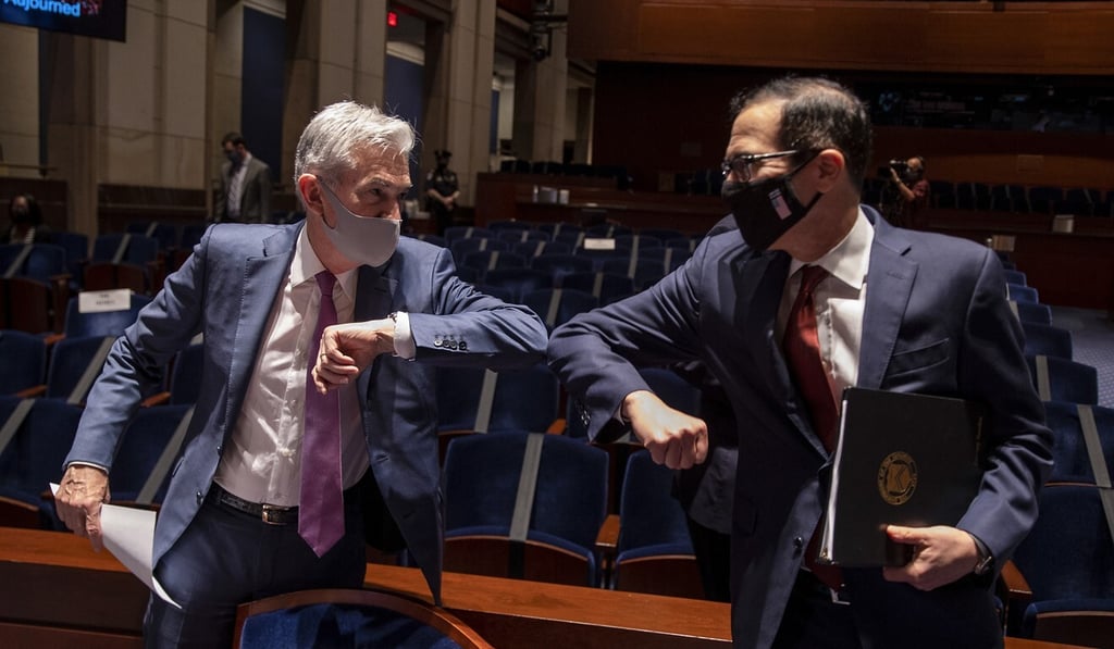 Federal Reserve chair Jerome Powell and US Secretary of the Treasury Steven Mnuchin greet each other in Washington on June 30, after testifying before the House Financial Services Committee on the response of their departments to the coronavirus pandemic. Photo: EPA-EFE