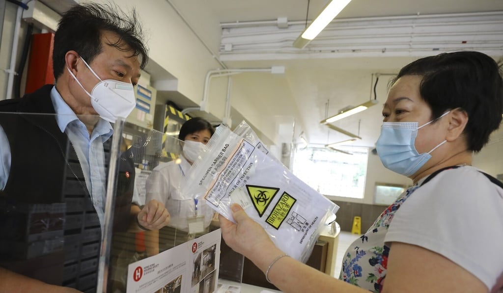 A resident of Lok Man Sun Chuen in To Kwa Wan collects a test pack. Photo: Dickson Lee A resident of Lok Man Sun Chuen in To Kwa Wan collects a test pack. Photo: Dickson Lee