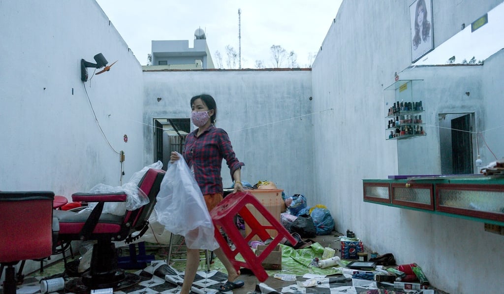 A woman works in a barbershop damaged by the Typhoon Molave in Quang Ngai province. Photo: Reuters A woman works in a barbershop damaged by the Typhoon Molave in Quang Ngai province. Photo: Reuters