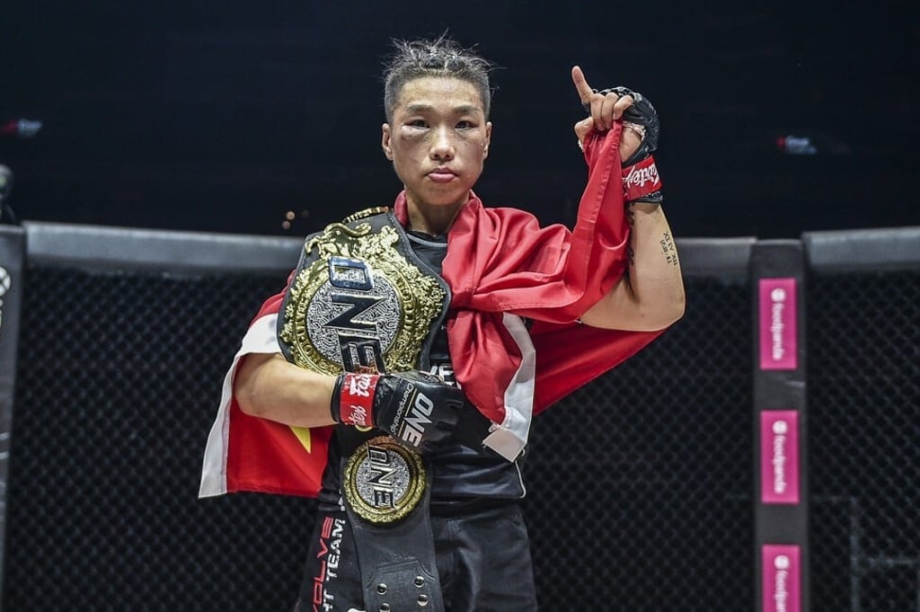 Xiong Jingnan celebrates with her strawweight belt after beating Tiffany Teo by unanimous decision. Xiong Jingnan celebrates with her strawweight belt after beating Tiffany Teo by unanimous decision.