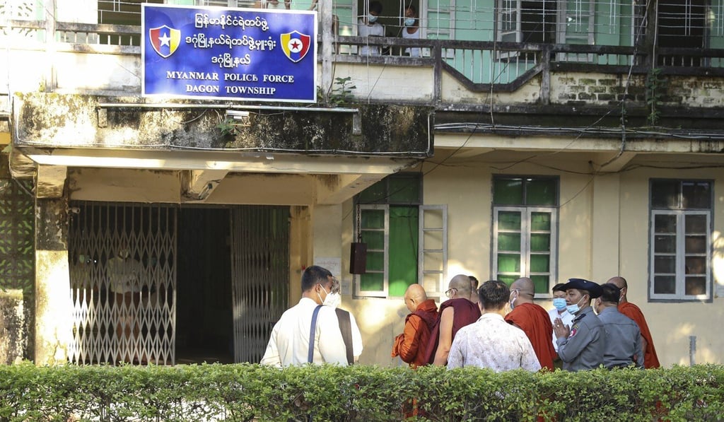 Buddhist monk Wirathu, second left, walks with his followers upon his arrival at a police station in Yangon on Monday. Photo: AP