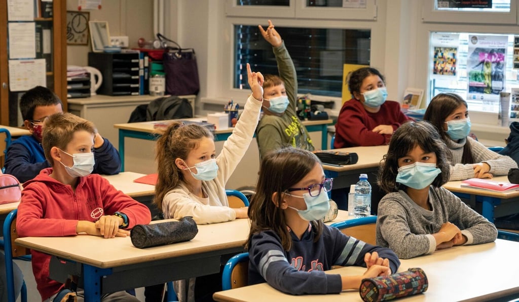 Pupils from a junior school in Bischwiller, eastern France, listen to their teacher, on Wednesday, as part of a tribute to slain history teacher Samuel Paty, who was beheaded by an attacker for showing pupils cartoons of the Prophet Mohammed in his civics class. Photo: AFP