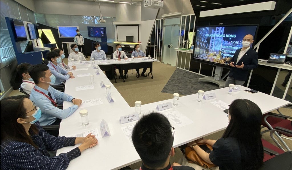 Eight talent from the Technology Leaders of Tomorrow programme attend a presentation during their training by Ivan Lam (far right), ASTRI’s director of strategy.