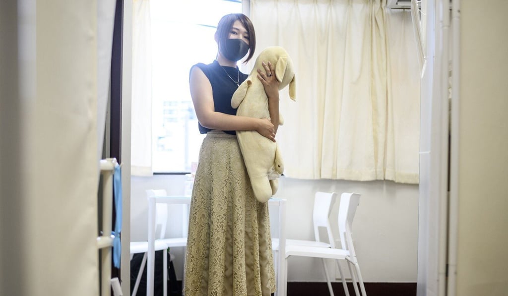 Yui Kato poses with her stuffed toy sheep Yuki-chan at Natsumi Clinic in Tokyo. Photo: AFP