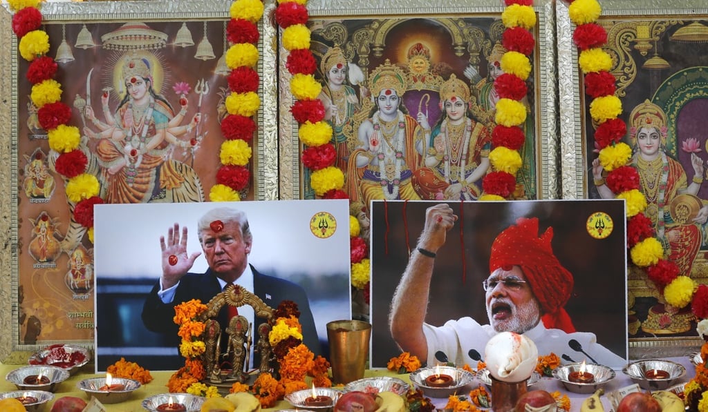 Photographs of Indian Prime Minister Narendra Modi and US President Donald Trump beside portraits of Hindu gods at a prayer ceremony in New Delhi, India. Photo: AP