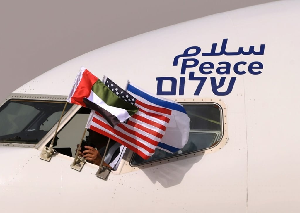 An aircraft of Israel’s El Al airline, adorned with the word ‘Peace’ in Arabic, English and Hebrew, flies the United Arab Emirates, Israel and US flags at Abu Dhabi airport after becoming the first-ever commercial flight from Israel to the UAE, on August 31, 2020. Photo: Agence France-Presse