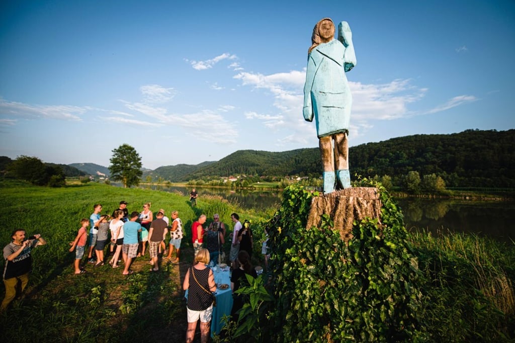 People gather around what conceptual artist Ales “Maxi” Zupevc claims is the first ever statue of Melania Trump, set in the fields near the first lady’s hometown of Sevnica, Slovenia, during its inauguration in 2019. Photo: Agence France-Presse