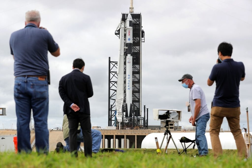 Photographers set up cameras in front of the SpaceX Falcon 9 rocket at the Kennedy Space Center in Florida. Photo: TNS Photographers set up cameras in front of the SpaceX Falcon 9 rocket at the Kennedy Space Center in Florida. Photo: TNS