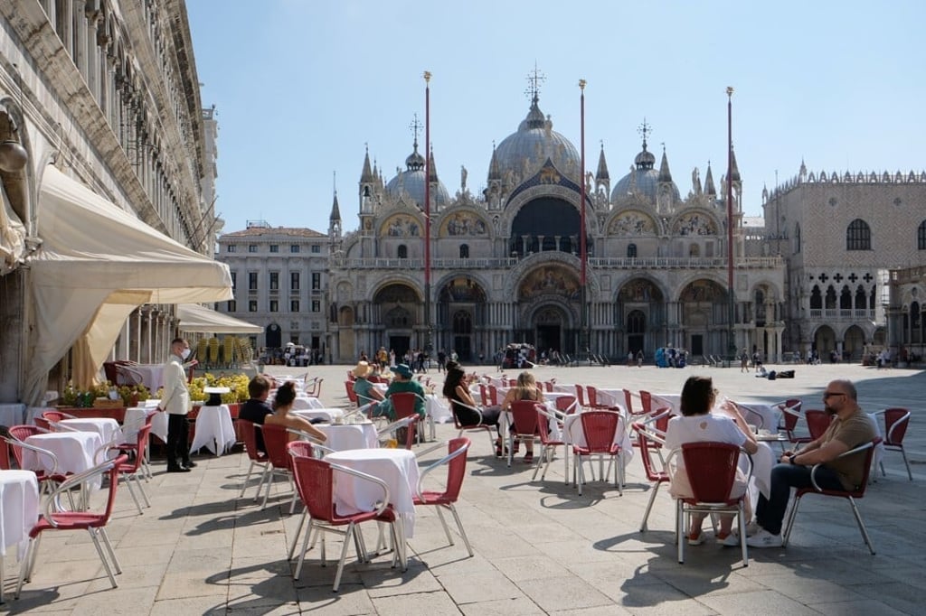 Tourists sit outside at a cafe in St Mark’s Square in Venice on June 14. A resurgence of Covid-19 cases across Europe has dimmed prospects for the continent’s hotel industry. Photo: Reuters Tourists sit outside at a cafe in St Mark’s Square in Venice on June 14. A resurgence of Covid-19 cases across Europe has dimmed prospects for the continent’s hotel industry. Photo: Reuters