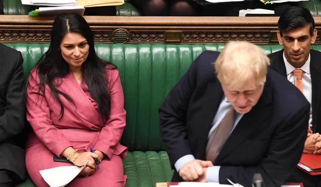 Britain's Prime Minister Boris Johnson, flanked by Britain's Home Secretary Priti Patel (L) and Britain's Chancellor of the Exchequer Rishi Sunak (R). File photo: AFP