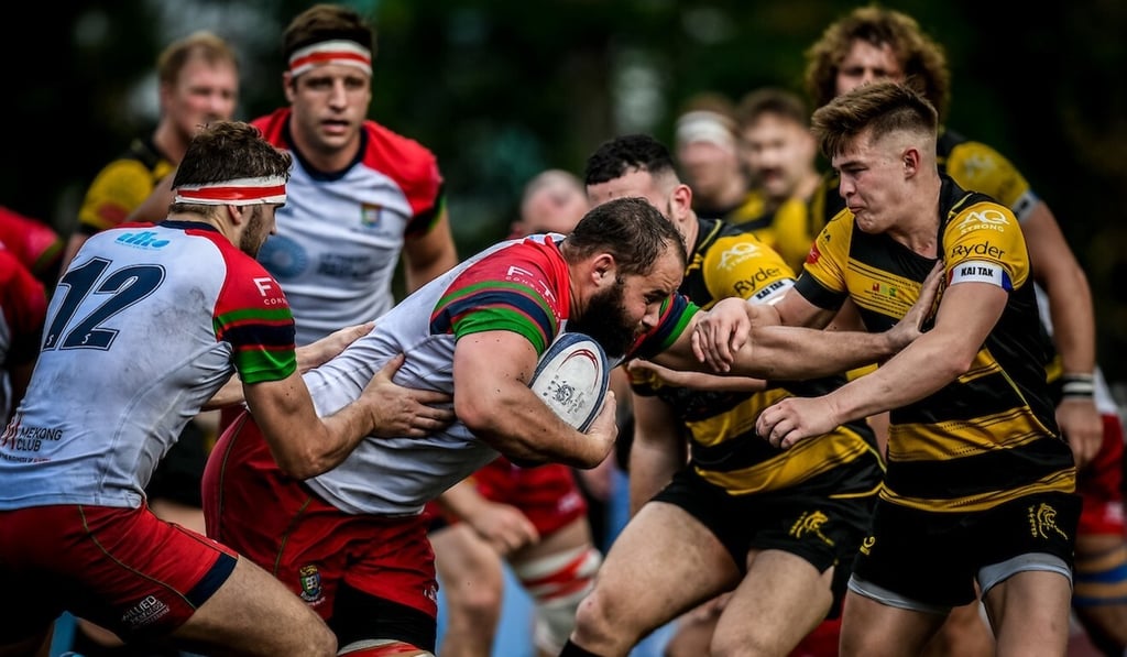 HKU Sandy Bay star Luke van der Smit runs into a powerful Tigers defensive line in the men's Premiership round three on Saturday. Photo: Ike Images