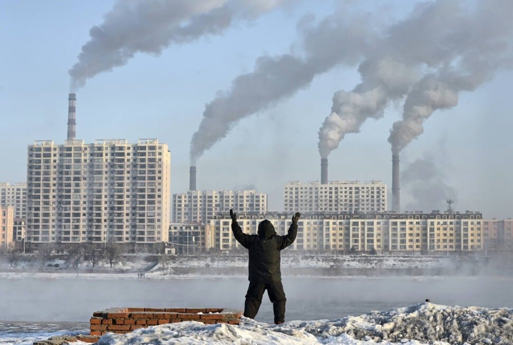 A man doing his morning exercises in front of chimney stacks across the Songhua River in Jilin province on February 24, 2013. Photo: Reuters A man doing his morning exercises in front of chimney stacks across the Songhua River in Jilin province on February 24, 2013. Photo: Reuters
