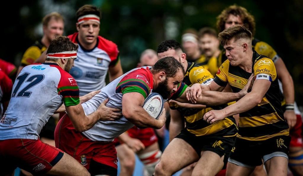 HKU Sandy Bay star Luke van der Smit runs into a powerful Tigers defensive line in the HKRU Premiership round three on Saturday. Photo: Ike Images HKU Sandy Bay star Luke van der Smit runs into a powerful Tigers defensive line in the HKRU Premiership round three on Saturday. Photo: Ike Images