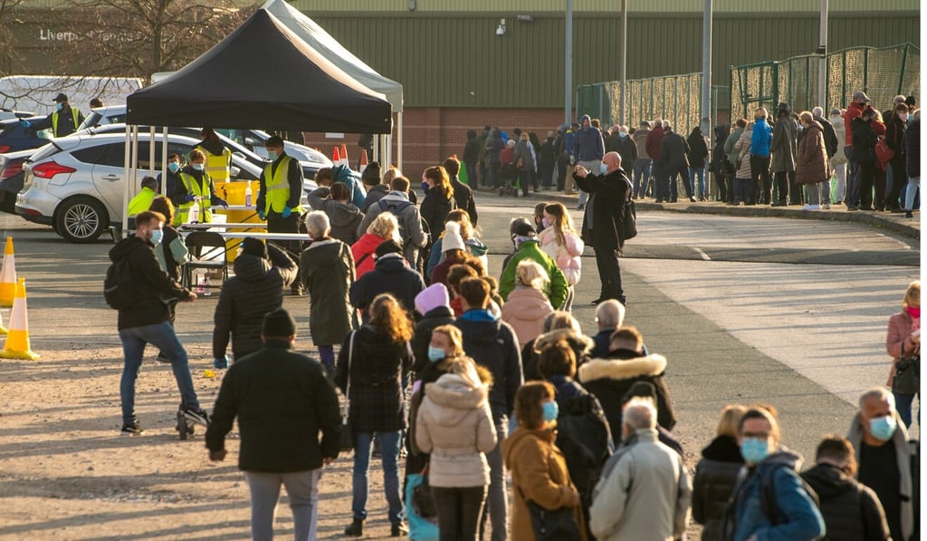 Visitors queue to enter an army-run Covid-19 testing centre in Liverpool. Photo: Bloomberg