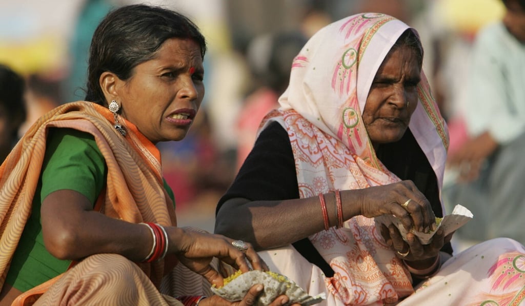 Dalit women eat rice at a homage site in Mumbai in this 2006 file photo. Photo: AFP