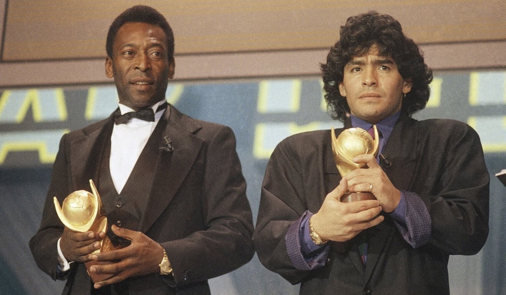 Diego Maradona (right) and Pele hold “Sports Oscar” trophies in Italy in March 1987. Photo: AP