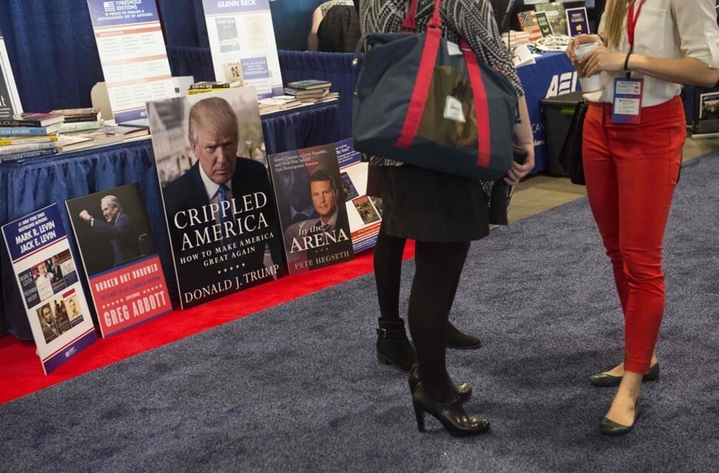 A poster of the cover of then-presidential hopeful Donald Trump’s 2015 book seen during the 2016 Conservative Political Action Conference (CPAC) in Maryland. Photo: AFP