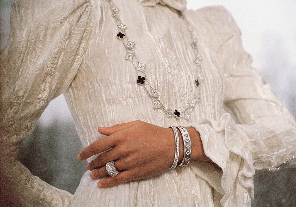 The Alhambra long necklace coupled with a new ring from the Perleé collection. Photo: Van Cleef & Arpels