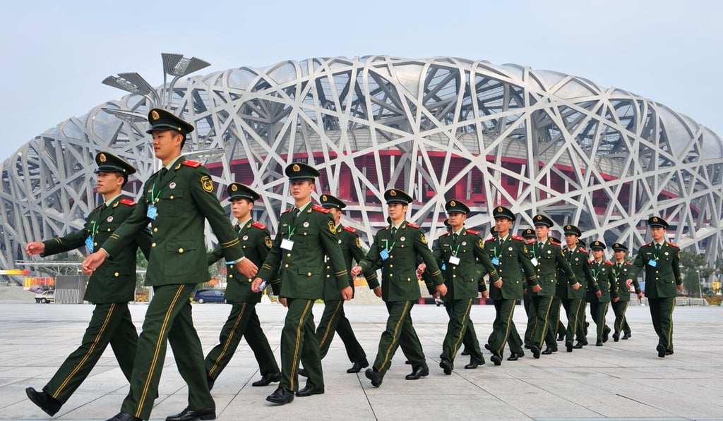 Chinese paramilitary soldiers march past the National Stadium, also known as the Bird's Nest, ahead of the opening ceremony of the 2008 Beijing Paralympic Games. Photo: AFP