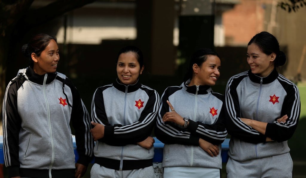 From left, female soldiers Krishna Kumari, Rashmi, Leela and Rachana smile as they speak with each other after being discharged from a quarantine at their army barracks in Kathmandu. Photo: Reuters