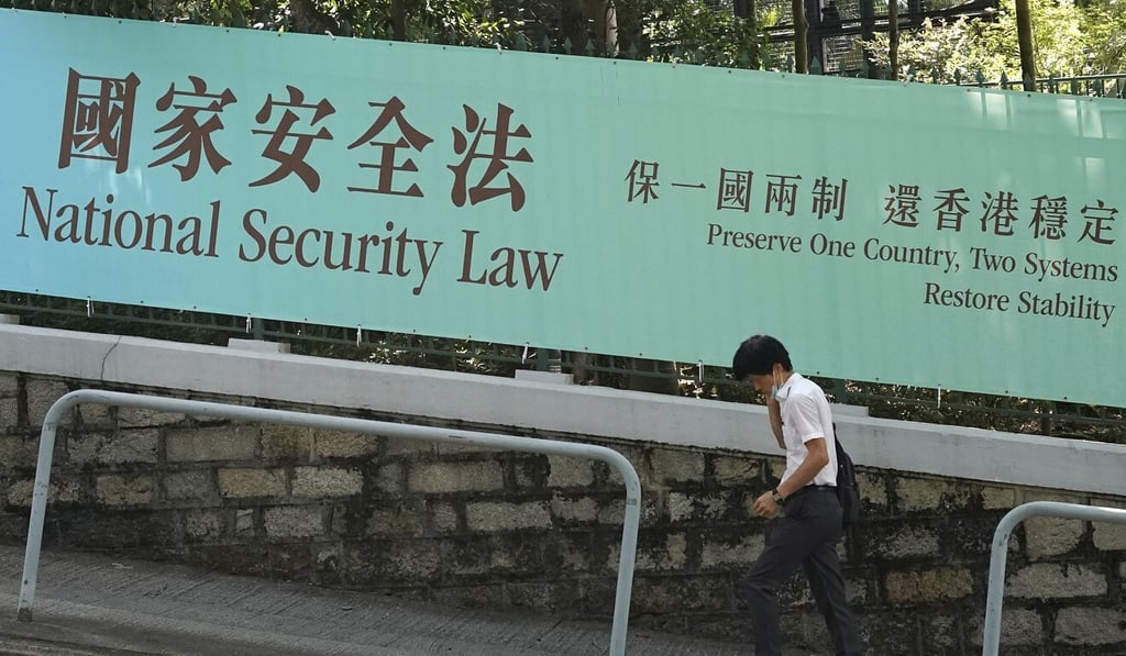 A man walks past a banner advertising the National Security Law in Central. Photo: Felix Wong A man walks past a banner advertising the National Security Law in Central. Photo: Felix Wong