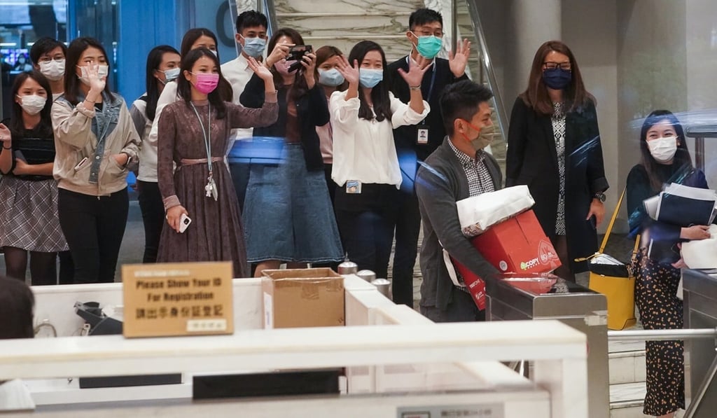 Employees of i-Cable wave goodbye to colleagues let go this week. Photo: Felix Wong