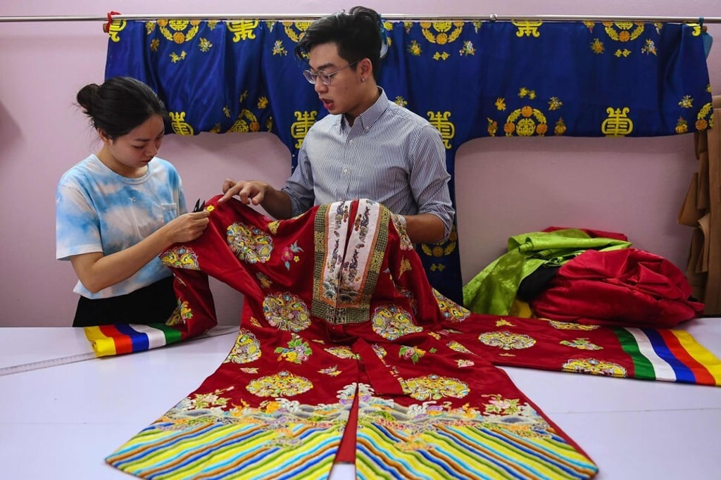 Nguyen Duc Loc, founder of the Y Van Hien company, checks an outfit based on traditional patterns and styles at the company’s workshop in Hanoi. Photo: AFP