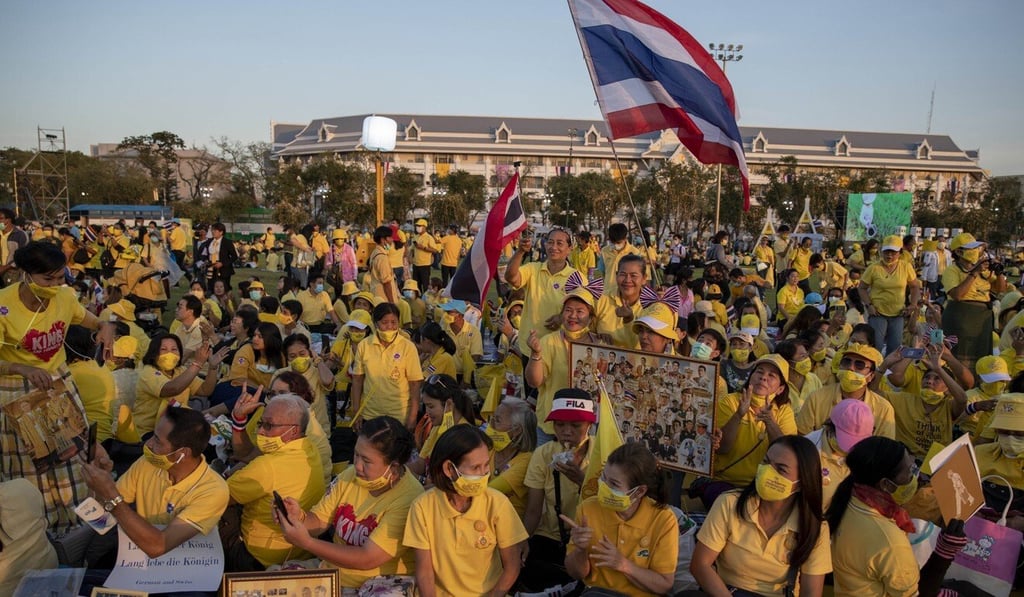 Supporters of the Thai monarchy display images of the royal family during a ceremony commemorating the late King Bhumibol Adulyadej. Photo: AP