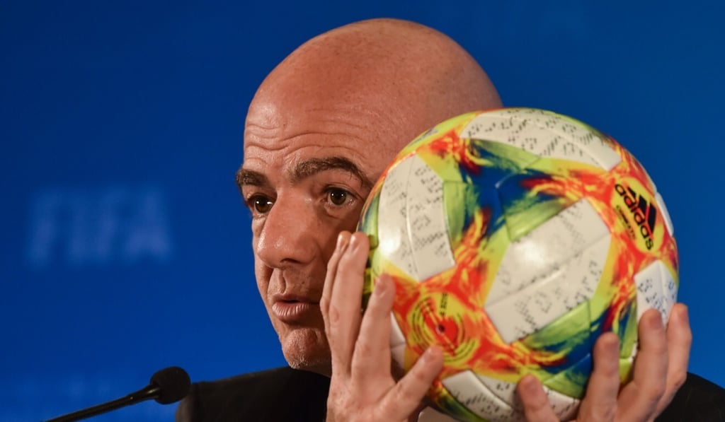 Fifa president Gianni Infantino holds a ball while speaking at a press conference during the football federation's Council meeting in Shanghai in October, 2019. Photo: AFP
