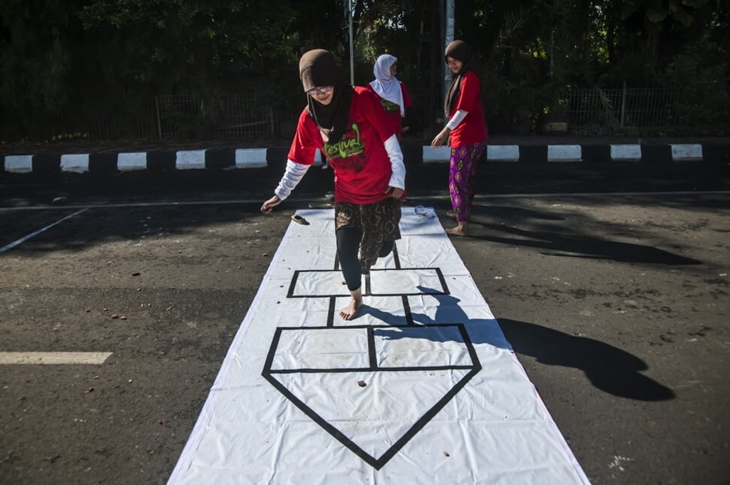 Engklek is similar to hopscotch. Photo: Pradita Utana/NurPhoto via Getty Images Engklek is similar to hopscotch. Photo: Pradita Utana/NurPhoto via Getty Images