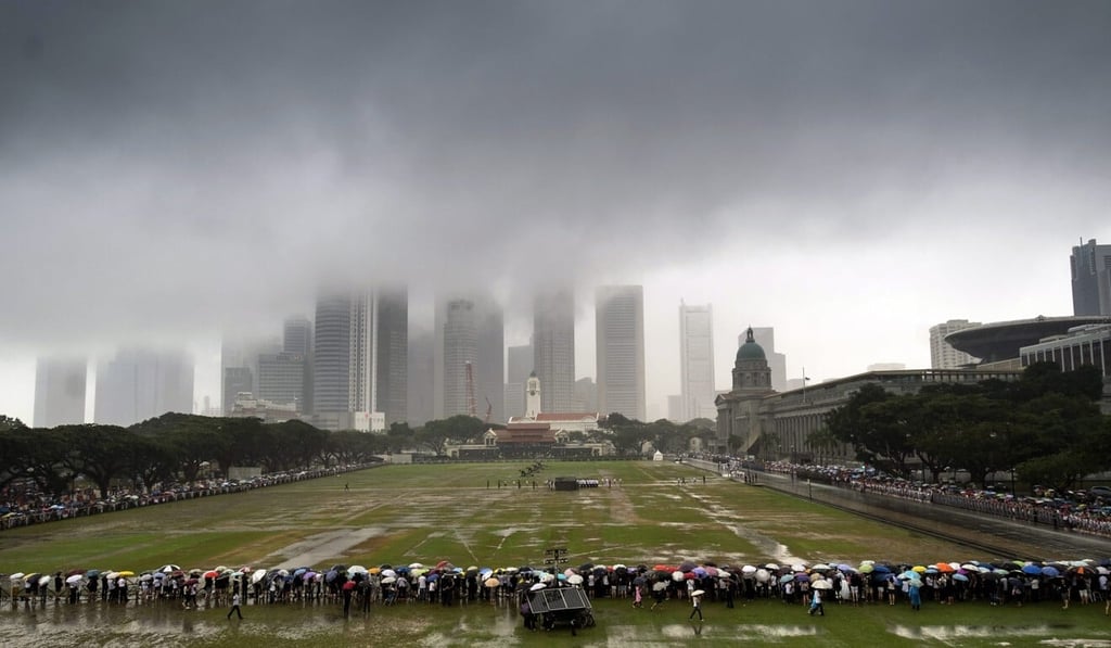 Crowds wait at the Padang in Singapore before the state funeral procession of former prime minister Lee Kuan Yew in March 2015. Photo: EPA