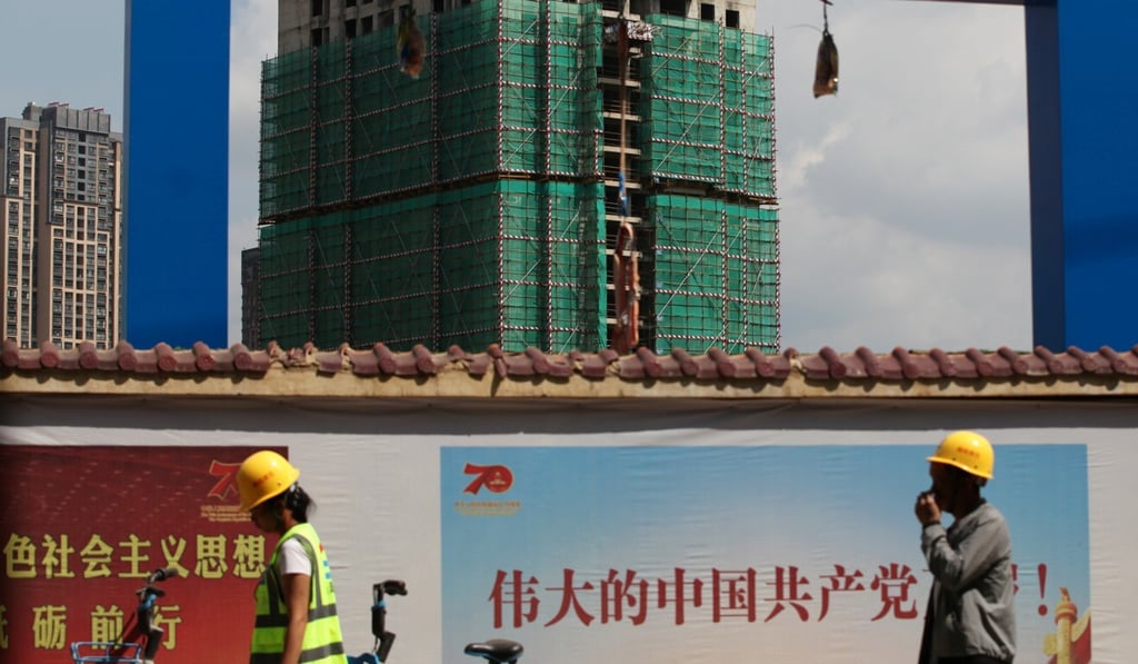 Workers walk past a construction site of residential buildings by property developer Country Garden in Kunming, Yunnan province. Photo: Reuters Workers walk past a construction site of residential buildings by property developer Country Garden in Kunming, Yunnan province. Photo: Reuters