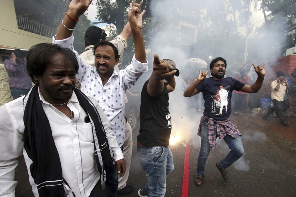 Fans of Rajinikanth celebrate the news of his political party launch in Chennai. Photo: AP