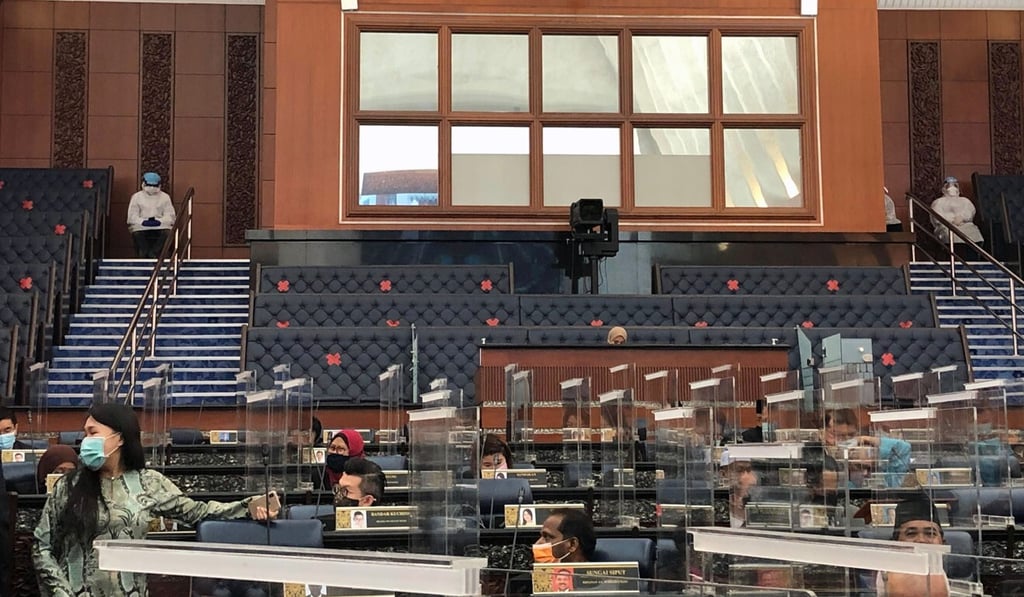 The ministers, wearing full personal protective equipment, are seen sat at the back of Monday’s parliamentary session in Kuala Lumpur. Photo: Handout / Teresa Kok / AFP The ministers, wearing full personal protective equipment, are seen sat at the back of Monday’s parliamentary session in Kuala Lumpur. Photo: Handout / Teresa Kok / AFP