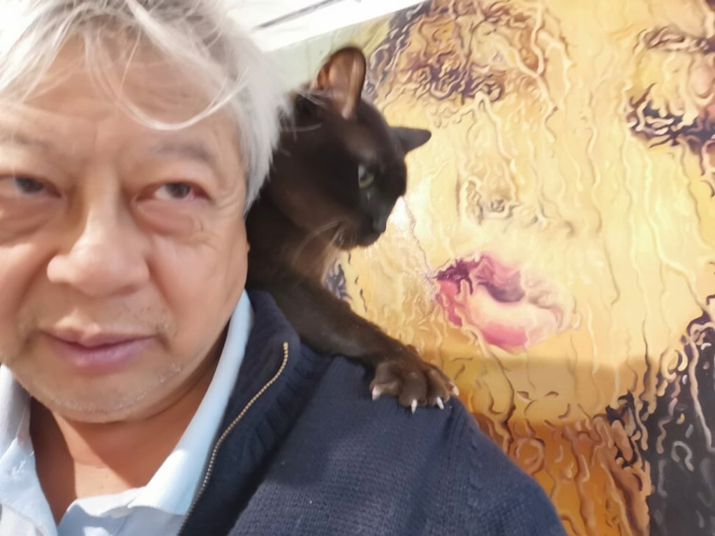 Wong How Man with his cat, Elvis. Photo: courtesy of Wong How Man