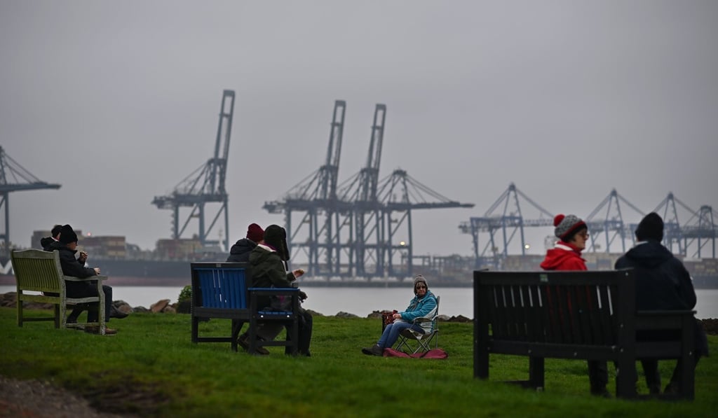 People take a break in view of cranes at the port of Felixstowe on December 12. Faced with the threat of a chaotic “no deal” departure from the EU, Britain must make good on its commitment to pivot to Asia. Photo: AFP People take a break in view of cranes at the port of Felixstowe on December 12. Faced with the threat of a chaotic “no deal” departure from the EU, Britain must make good on its commitment to pivot to Asia. Photo: AFP