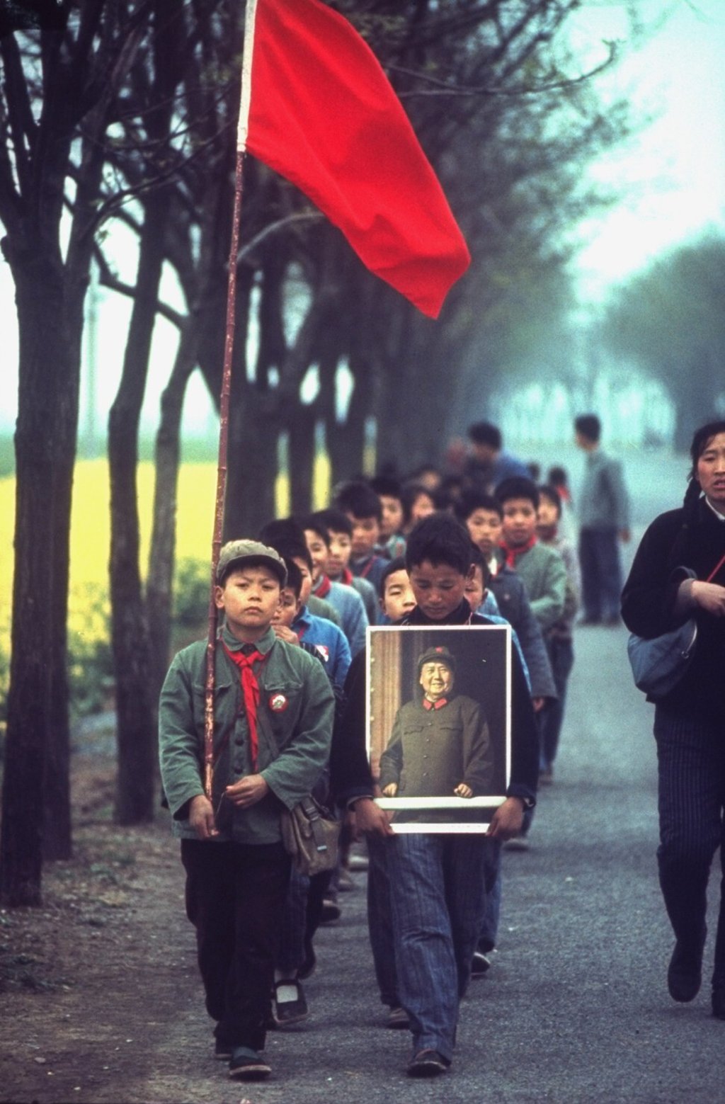 Chinese schoolchildren marching along the road carrying a red communist flag and a portrait of Chairman Mao Zedong in Lo Wu, Hong Kong. Photo: courtesy The University of Hong Kong Libraries Chinese schoolchildren marching along the road carrying a red communist flag and a portrait of Chairman Mao Zedong in Lo Wu, Hong Kong. Photo: courtesy The University of Hong Kong Libraries