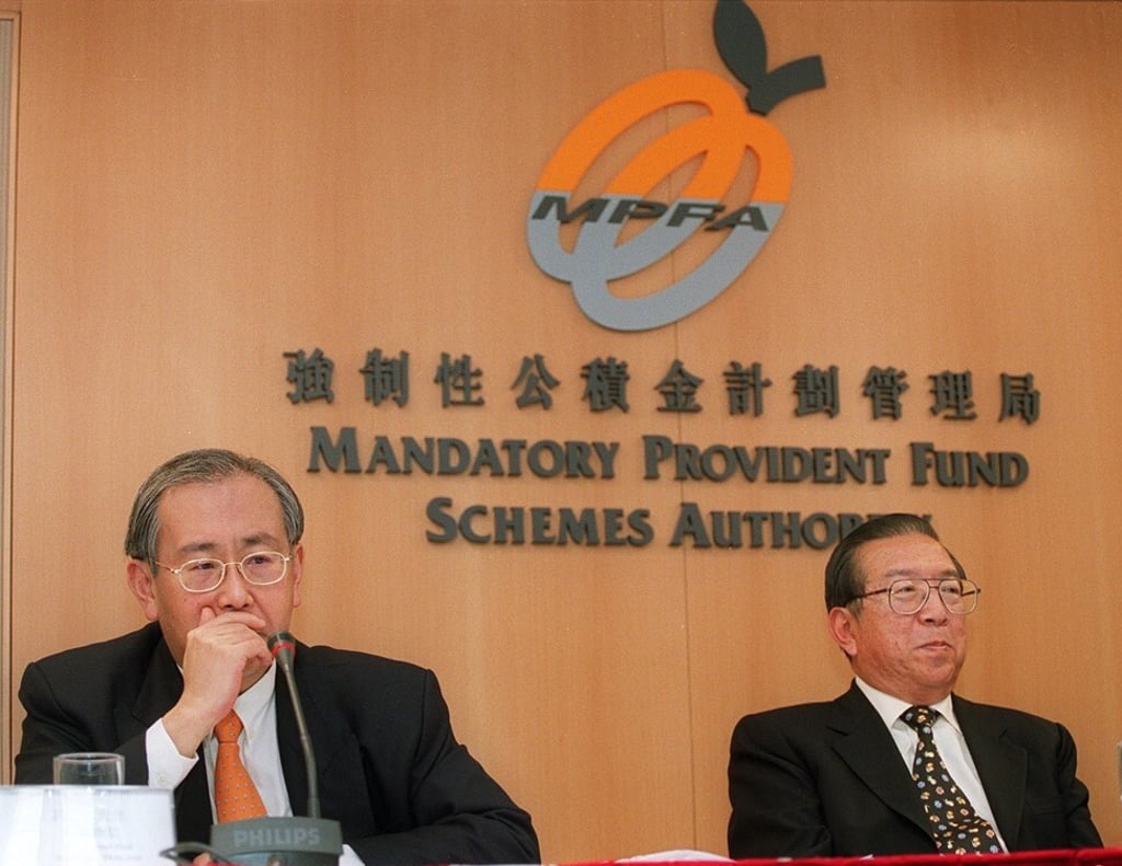 Then MPF Schemes Authority managing director Rafael Hui Si-yan (left) and chairman Charles Lee Yeh-kwong speak to reporters on the first day of the MPF’s operation on December 1, 2000. Photo: Handout